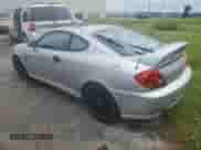 2003 Hyundai Tiburon GT с VIN KMHHN65F93U019840, выставлен на аукционе Copart как лот 74063394 с пробегом Не указан миль и На запчасти • Non repairable. История ставок и продаж доступна на DreamBid. Изображение 2.