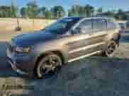 2015 Jeep Grand Cherokee Overland z VIN 1C4RJECG2FC199165, wystawiony jako Copart lot #66711265 z przebiegiem 182 093 mil mil oraz Szkoda całkowita • Salvage title. Historia ofert i sprzedaży dostępna na DreamBid. Obrazek 1.