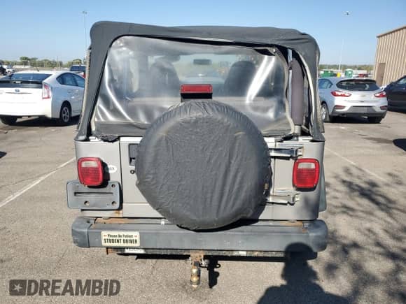 2000 Jeep Wrangler SE with VIN 1J4FA29P4YP775935, listed as a Copart auction lot 80458955 with 100,211 mi miles and Salvage title. Bid and sale history available at DreamBid. Image 6.