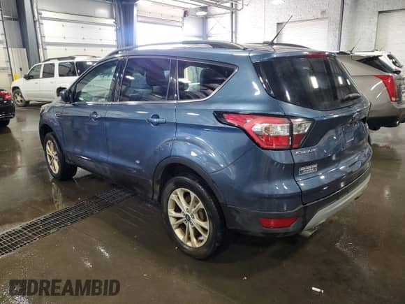2018 Ford Escape SE with VIN 1FMCU9GD8JUB06670, listed as a Copart auction lot 63287435 with 128,747 mi miles and Salvage title. Bid and sale history available at DreamBid. Image 2.
