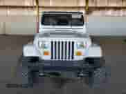 1989 Jeep Wrangler with VIN 2J4FY29T8KJ168644, listed as a Copart auction lot 66119895 with 142,476 mi miles and Salvage title. Bid and sale history available at DreamBid. Image 5.