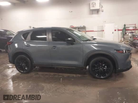 2022 Mazda CX-5 S Carbon Edition z VIN JM3KFBCM3N0527885, wystawiony jako IAAI lot #41226356 z przebiegiem 25 691 mil mil oraz . Historia ofert i sprzedaży dostępna na DreamBid. Obrazek 13.