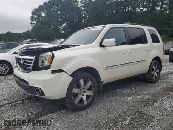 2014 Honda Pilot Touring with VIN 5FNYF4H97EB041584, listed as a Copart auction lot 66761435 with 121,127 mi miles and Salvage title. Bid and sale history available at DreamBid. Image 1.