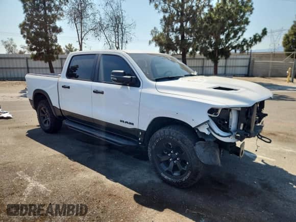 2023 Ram 1500 Rebel with VIN 1C6SRFLT1PN522079, listed as a Copart auction lot 64834075 with 27,488 mi miles and Salvage title. Bid and sale history available at DreamBid. Image 4.