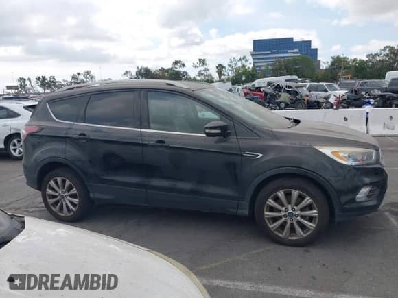 2017 Ford Escape Titanium with VIN 1FMCU0J97HUB04015, listed as a IAAI auction lot 43211466 with 200,577 mi miles and . Bid and sale history available at DreamBid. Image 12.