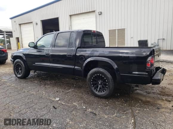2003 Dodge Dakota Sport z VIN 1D7HL38X33S251719, wystawiony jako Copart lot #67171105 z przebiegiem 159 451 mil mil oraz Szkoda całkowita • Salvage title. Historia ofert i sprzedaży dostępna na DreamBid. Obrazek 2.
