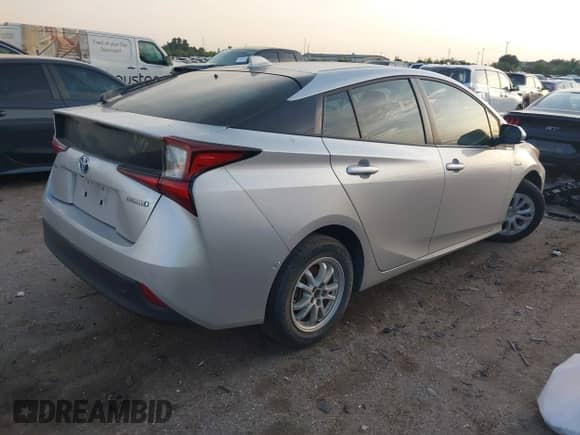 2021 Toyota Prius L Eco with VIN JTDKAMFUXM3143243, listed as a IAAI auction lot 43079577 with 87,002 mi miles and . Bid and sale history available at DreamBid. Image 4.