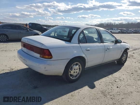 1996 Saturn SL with VIN 1G8ZK5279TZ162812, listed as a Copart auction lot 87079874 with 143,461 mi miles and Salvage title. Bid and sale history available at DreamBid. Image 3.