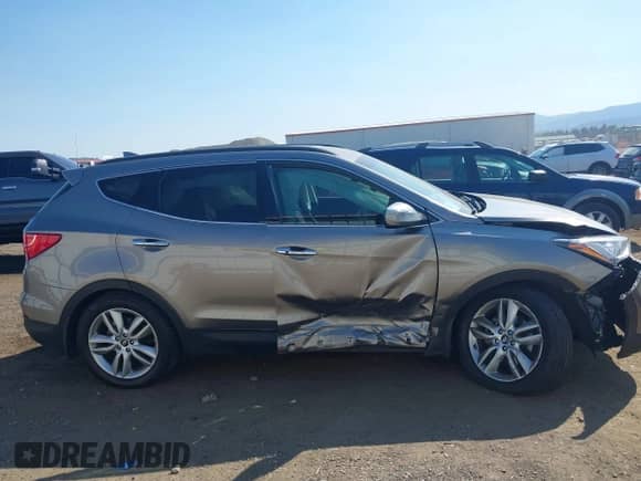 2014 Hyundai Santa Fe z VIN 5XYZUDLA8EG200097, wystawiony jako IAAI lot #43045747 z przebiegiem 31 772 mil mil oraz . Historia ofert i sprzedaży dostępna na DreamBid. Obrazek 13.