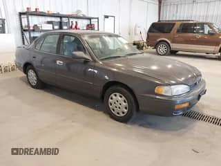 1996 Toyota Camry DX z VIN 4T1BG12K9TU949712, wystawiony jako IAAI lot #42982766 z przebiegiem 258 942 mil mil oraz . Historia ofert i sprzedaży dostępna na DreamBid. Obrazek 1.