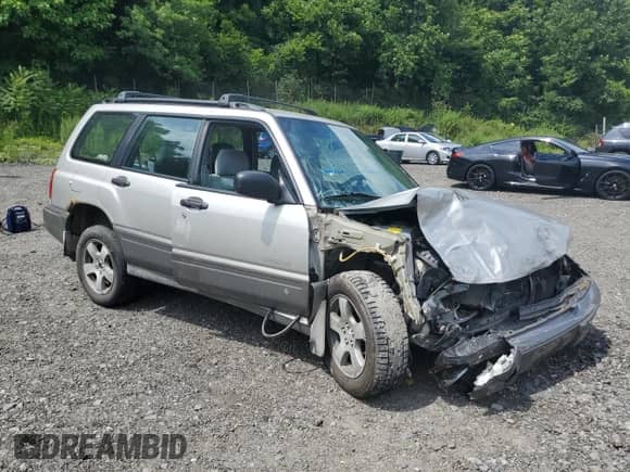 1999 Subaru Forester S with VIN JF1SF6557XH730701, listed as a Copart auction lot 65169235 with 142,246 mi miles and Salvage title. Bid and sale history available at DreamBid. Image 4.