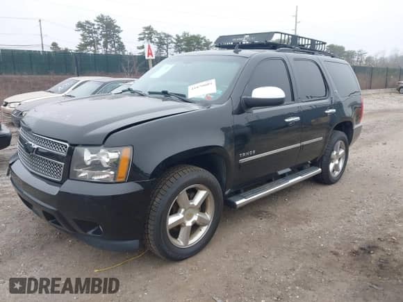 2014 Chevrolet Tahoe LTZ with VIN 1GNSKCE07ER142112, listed as a IAAI auction lot 41870089 with 168,575 mi miles and . Bid and sale history available at DreamBid. Image 2.