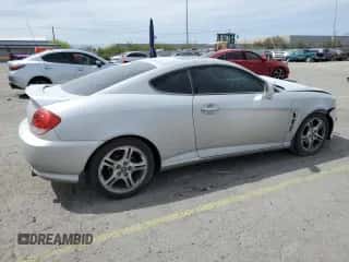 2006 Hyundai Tiburon GT с VIN KMHHN65F06U203701, выставлен на аукционе Copart как лот 52374135 с пробегом 90 796 миль миль и Списание • Salvage title. История ставок и продаж доступна на DreamBid. Изображение 3.