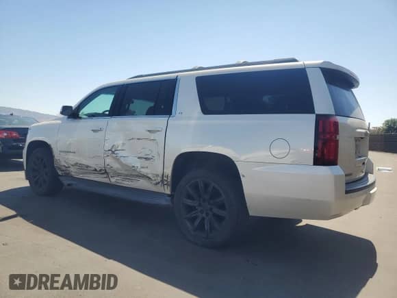 2015 Chevrolet Suburban LT with VIN 1GNSKJKC4FR739657, listed as a Copart auction lot 70586615 with 116,344 mi miles and Salvage title. Bid and sale history available at DreamBid. Image 2.