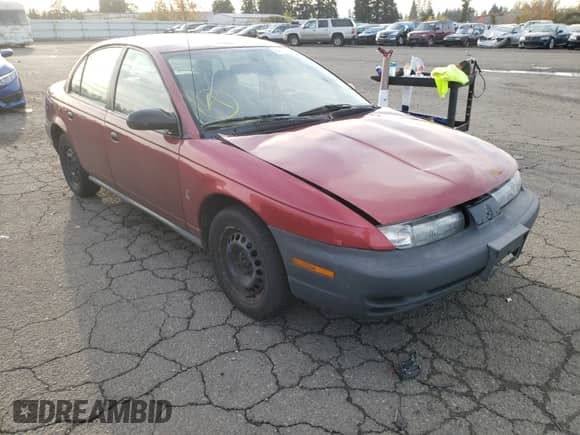 1999 Saturn SL with VIN 1G8ZH5286XZ192072, listed as a Copart auction lot 80973254 with 254,855 mi miles and Salvage title. Bid and sale history available at DreamBid. Image 1.