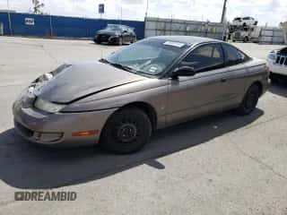 1999 Saturn SC with VIN 1G8ZN1288XZ310351, listed as a Copart auction lot 76677414 with Not provided miles and Salvage title. Bid and sale history available at DreamBid. Image 1.