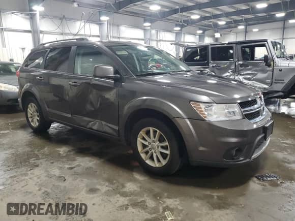 2017 Dodge Journey SXT with VIN 3C4PDDBG1HT561018, listed as a Copart auction lot 69006095 with 136,612 mi miles and Salvage title. Bid and sale history available at DreamBid. Image 4.