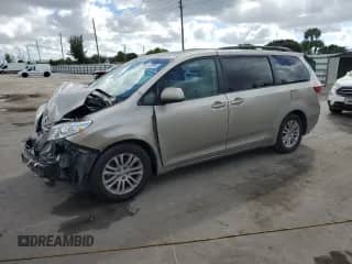 2015 Toyota Sienna XLE with VIN 5TDYK3DC5FS580533, listed as a Copart auction lot 82233965 with 165,489 mi miles and Salvage title. Bid and sale history available at DreamBid. Image 1.