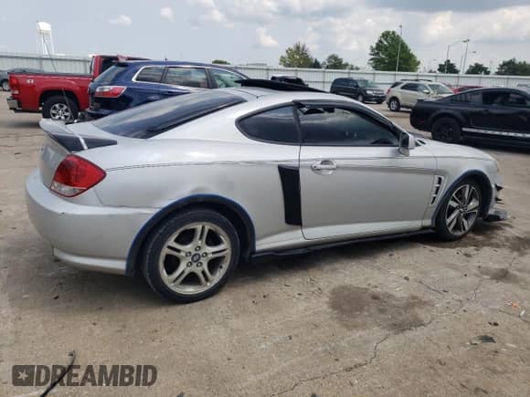 2006 Hyundai Tiburon GS с VIN KMHHM65D66U226482, выставлен на аукционе Copart как лот 64059334 с пробегом 93 932 миль миль и Списание • Salvage title. История ставок и продаж доступна на DreamBid. Изображение 3.