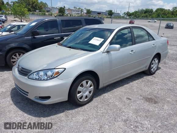 2002 Toyota Camry LE with VIN JTDBE32K520113147, listed as a IAAI auction lot 42350611 with 265,485 mi miles and . Bid and sale history available at DreamBid. Image 2.