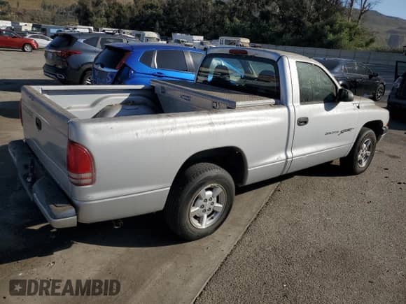 2001 Dodge Dakota z VIN 1B7FL26X71S150095, wystawiony jako Copart lot #69853224 z przebiegiem 99 736 mil mil oraz Czysty tytuł • Clean title. Historia ofert i sprzedaży dostępna na DreamBid. Obrazek 3.