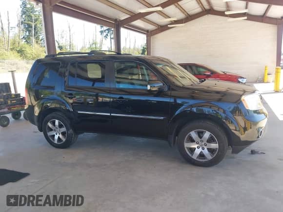 2012 Honda Pilot Touring with VIN 5FNYF4H99CB075099, listed as a IAAI auction lot 42674383 with 203,684 mi miles and . Bid and sale history available at DreamBid. Image 14.