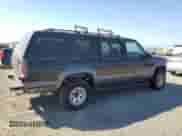 1999 Chevrolet Suburban z VIN 1GNGK26R5XJ513945, wystawiony jako Copart lot #73673314 z przebiegiem 198 656 mil mil oraz Czysty tytuł • Clean title. Historia ofert i sprzedaży dostępna na DreamBid. Obrazek 3.