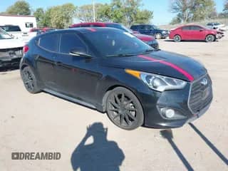 2016 Hyundai Veloster Turbo z VIN KMHTC6AE9GU261675, wystawiony jako IAAI lot #43472782 z przebiegiem 158 995 mil mil oraz . Historia ofert i sprzedaży dostępna na DreamBid. Obrazek 1.