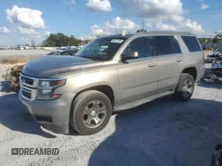 2018 Chevrolet Tahoe LS with VIN 1GNSCAKC9JR313890, listed as a Copart auction lot 89547405 with 142,022 mi miles and Salvage title. Bid and sale history available at DreamBid. Image 1.