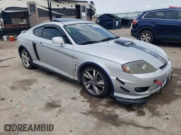 2006 Hyundai Tiburon GS с VIN KMHHM65D66U226482, выставлен на аукционе Copart как лот 64059334 с пробегом 93 932 миль миль и Списание • Salvage title. История ставок и продаж доступна на DreamBid. Изображение 4.