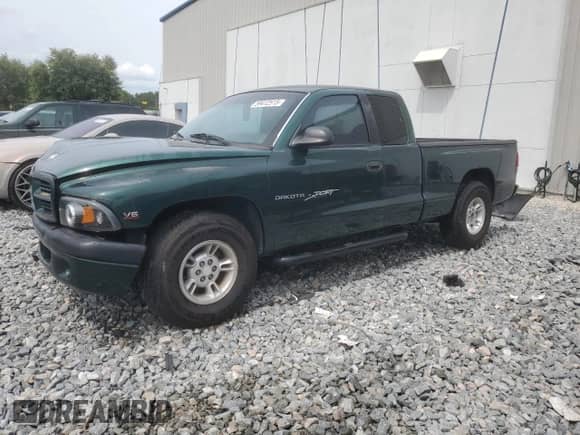 1999 Dodge Dakota SLT with VIN 1B7GL22X8XS283614, listed as a Copart auction lot 59412515 with 69,705 mi miles and Salvage title. Bid and sale history available at DreamBid. Image 1.