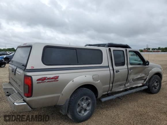 2003 Nissan Frontier XE with VIN 1N6ED29Y83C461767, listed as a Copart auction lot 58077425 with 164,955 mi miles and Salvage title. Bid and sale history available at DreamBid. Image 3.
