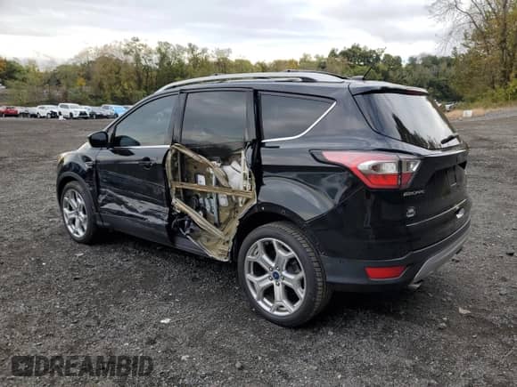2017 Ford Escape Titanium with VIN 1FMCU0J90HUB64587, listed as a Copart auction lot 86682055 with 64,514 mi miles and Salvage title. Bid and sale history available at DreamBid. Image 2.