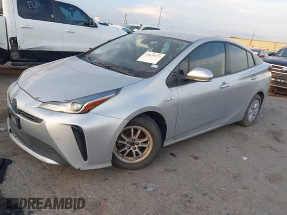 2021 Toyota Prius L Eco with VIN JTDKAMFUXM3143243, listed as a IAAI auction lot 43079577 with 87,002 mi miles and . Bid and sale history available at DreamBid. Image 2.