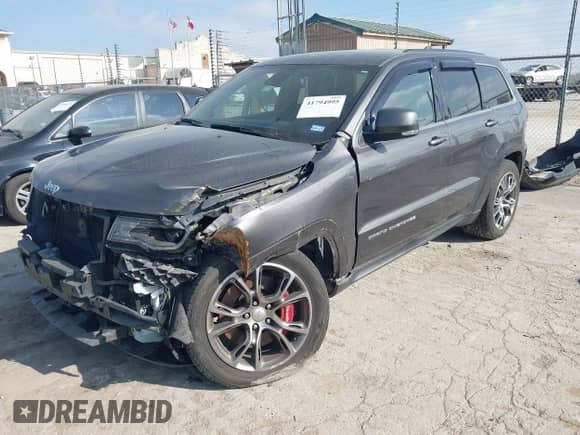 2014 Jeep Grand Cherokee SRT-8 z VIN 1C4RJFDJXEC390248, wystawiony jako IAAI lot #41794995 z przebiegiem 87 881 mil mil oraz . Historia ofert i sprzedaży dostępna na DreamBid. Obrazek 2.
