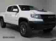 2020 Chevrolet Colorado 4WD ZR2 with VIN 1GCPTEE19L1134962, listed as a Copart auction lot 59032865 with 143,010 mi miles and Salvage title. Bid and sale history available at DreamBid. Image 1.