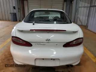 1997 Hyundai Tiburon с VIN KMHJG24M6VU052589, выставлен на аукционе Copart как лот 45118235 с пробегом 90 609 миль миль и Списание • Salvage title. История ставок и продаж доступна на DreamBid. Изображение 6.