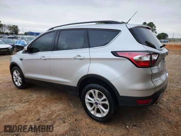 2018 Ford Escape SE with VIN 1FMCU9GD2JUB39549, listed as a Copart auction lot 84175385 with 127,811 mi miles and Salvage title. Bid and sale history available at DreamBid. Image 2.