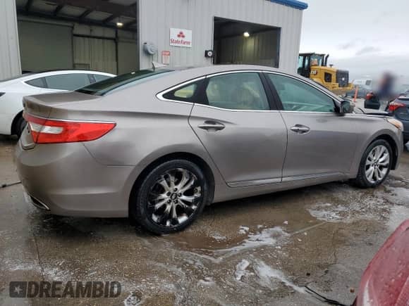 2013 Hyundai Azera с VIN KMHFG4JG0DA288574, выставлен на аукционе Copart как лот 83459544 с пробегом 179 327 миль миль и Списание • Salvage title. История ставок и продаж доступна на DreamBid. Изображение 3.
