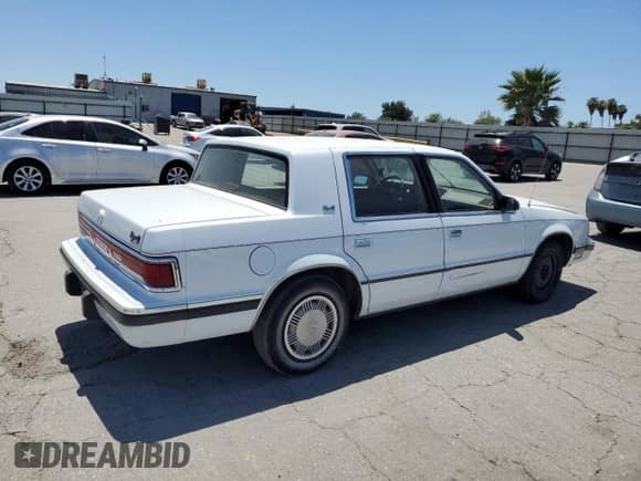 1989 Dodge Dynasty with VIN 1B3BC463XKD594439, listed as a Copart auction lot 65792195 with 61,970 mi miles and Clean title. Bid and sale history available at DreamBid. Image 3.