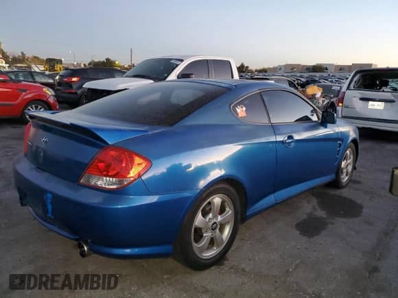 2005 Hyundai Tiburon GS with VIN KMHHM65D65U183681, listed as a Copart auction lot 86779914 with 190,575 mi miles and Clean title. Bid and sale history available at DreamBid. Image 3.