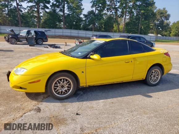 2001 Saturn SC with VIN 1G8ZY12771Z320035, listed as a Copart auction lot 80707645 with 149,680 mi miles and Salvage title. Bid and sale history available at DreamBid. Image 1.