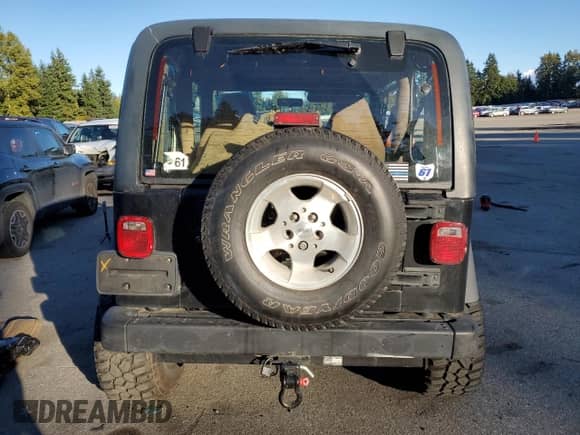 1997 Jeep Wrangler Sahara with VIN 1J4FY49SXVP486730, listed as a Copart auction lot 82473255 with 143,015 mi miles and Salvage title. Bid and sale history available at DreamBid. Image 6.