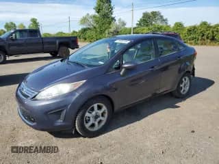 2012 Ford Fiesta SE with VIN 3FADP4BJ6CM204786, listed as a Copart auction lot 70699705 with 101,559 mi miles and Salvage title. Bid and sale history available at DreamBid. Image 1.
