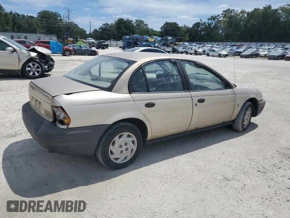 1997 Saturn SL z VIN 1G8ZF5288VZ115030, wystawiony jako Copart lot #80317135 z przebiegiem 259 292 mil mil oraz Szkoda całkowita • Salvage title. Historia ofert i sprzedaży dostępna na DreamBid. Obrazek 3.