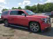 2015 Chevrolet Suburban LTZ with VIN 1GNSKKKC7FR563340, listed as a Copart auction lot 68143455 with 233,737 mi miles and Salvage title. Bid and sale history available at DreamBid. Image 4.