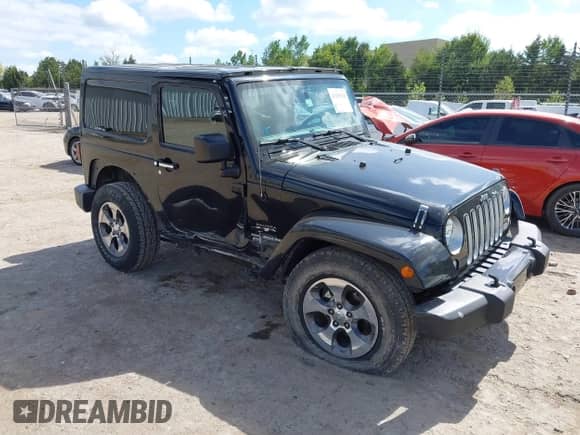 2016 Jeep Wrangler Sahara z VIN 1C4AJWBG2GL108479, wystawiony jako IAAI lot #43295339 z przebiegiem 57 237 mil mil oraz . Historia ofert i sprzedaży dostępna na DreamBid. Obrazek 1.
