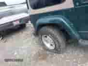 1999 Jeep Wrangler Sahara z VIN 1J4FY49S5XP482037, wystawiony jako IAAI lot #42341723 z przebiegiem 161 081 mil mil oraz . Historia ofert i sprzedaży dostępna na DreamBid. Obrazek 6.