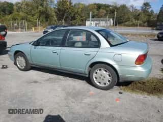 1997 Saturn SL with VIN 1G8ZK5274VZ271990, listed as a Copart auction lot 87279155 with 147,825 mi miles and Salvage title. Bid and sale history available at DreamBid. Image 2.