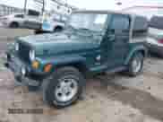 1999 Jeep Wrangler Sahara z VIN 1J4FY49S5XP482037, wystawiony jako IAAI lot #42341723 z przebiegiem 161 081 mil mil oraz . Historia ofert i sprzedaży dostępna na DreamBid. Obrazek 2.